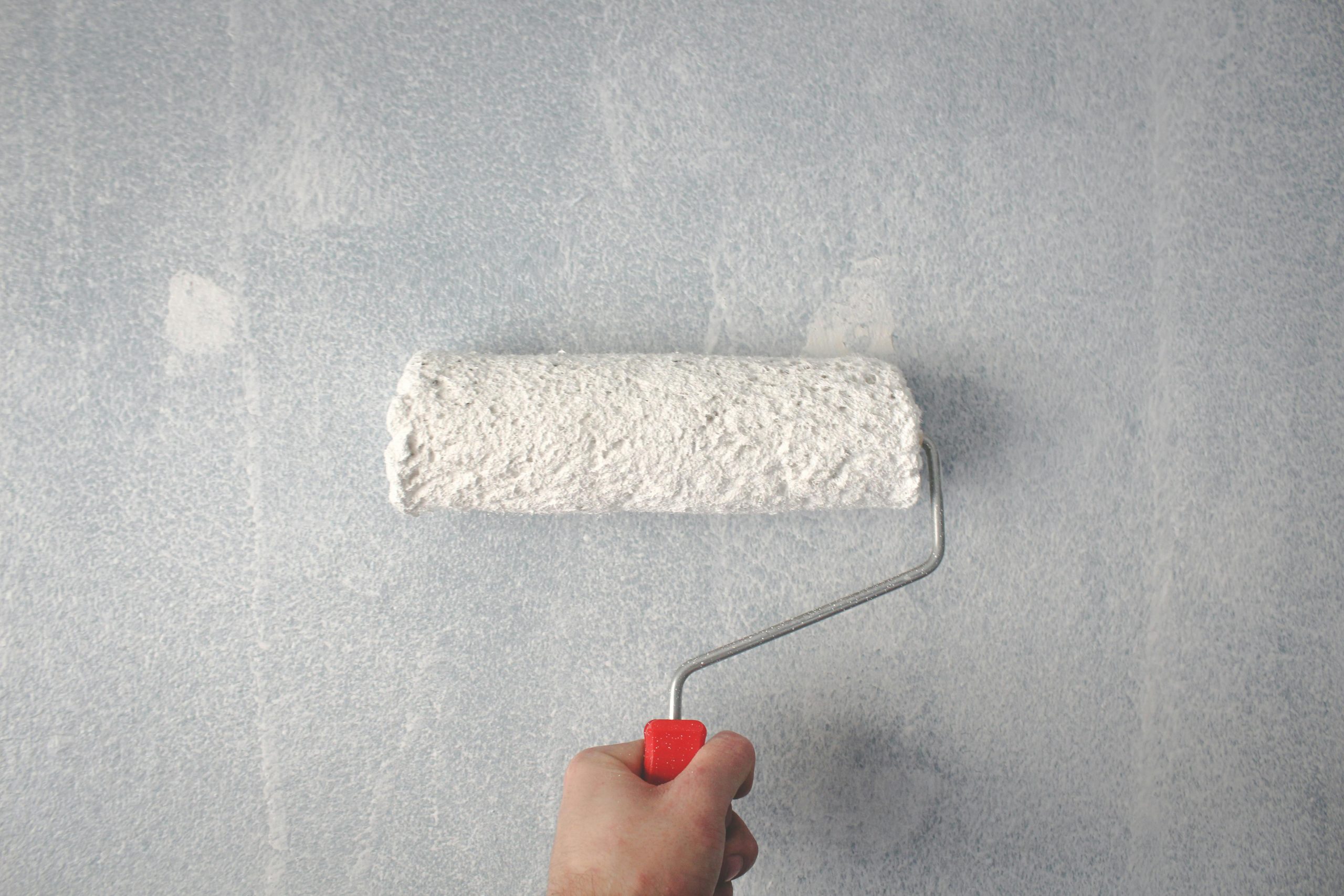 Paint roller painting wall